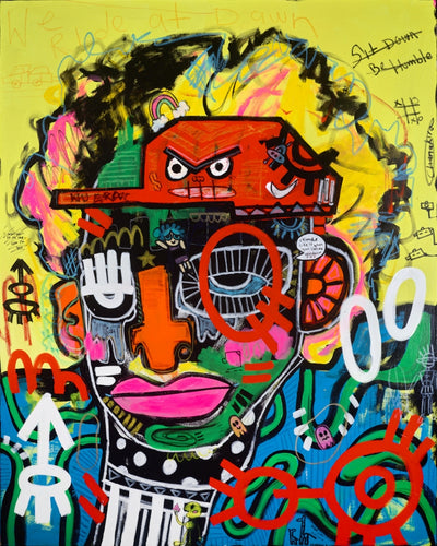 A vibrant, multicolored graffiti-style portrait painting of a face with bold black hair, featuring a red truck on the forehead, pink lips, and a bright yellow background with graffiti tags and scribbles.
