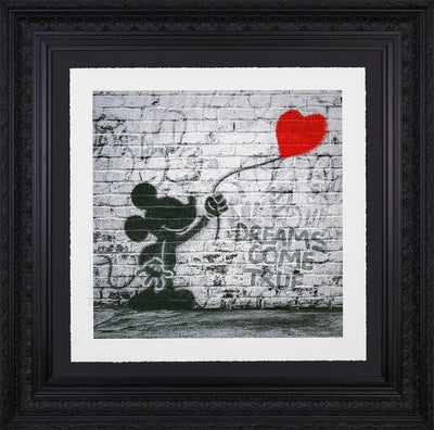 Black and white graffiti-style artwork by Mr. Brainwash depicting Mickey Mouse and a spray-painting of a red heart balloon on a brick wall. The phrase ‘DREAMS COME TRUE’ is stencilled beside him.